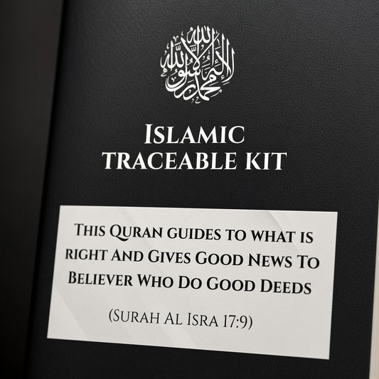 A close-up of a black book or booklet cover with white text reading 'ISLAMIC TRACEABLE KIT' and a white label below containing a Quranic verse. The cover has a subtle textured finish and a white circular Arabic calligraphy emblem near the top.